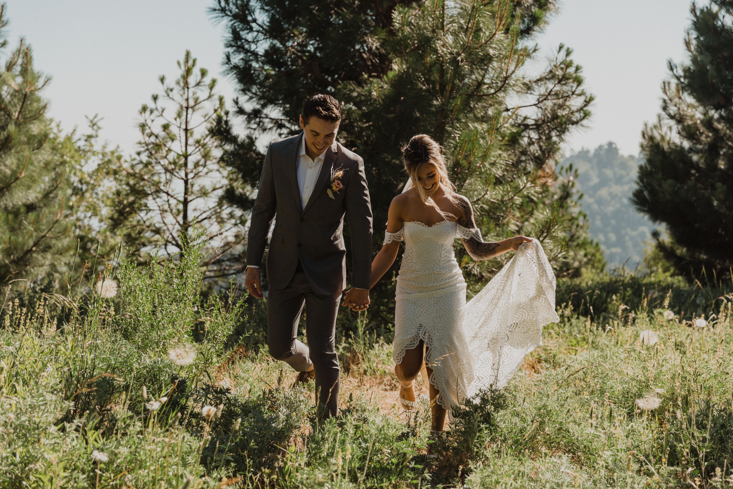 a couple walks through a field during their intimate wedding in the mountains of southern California