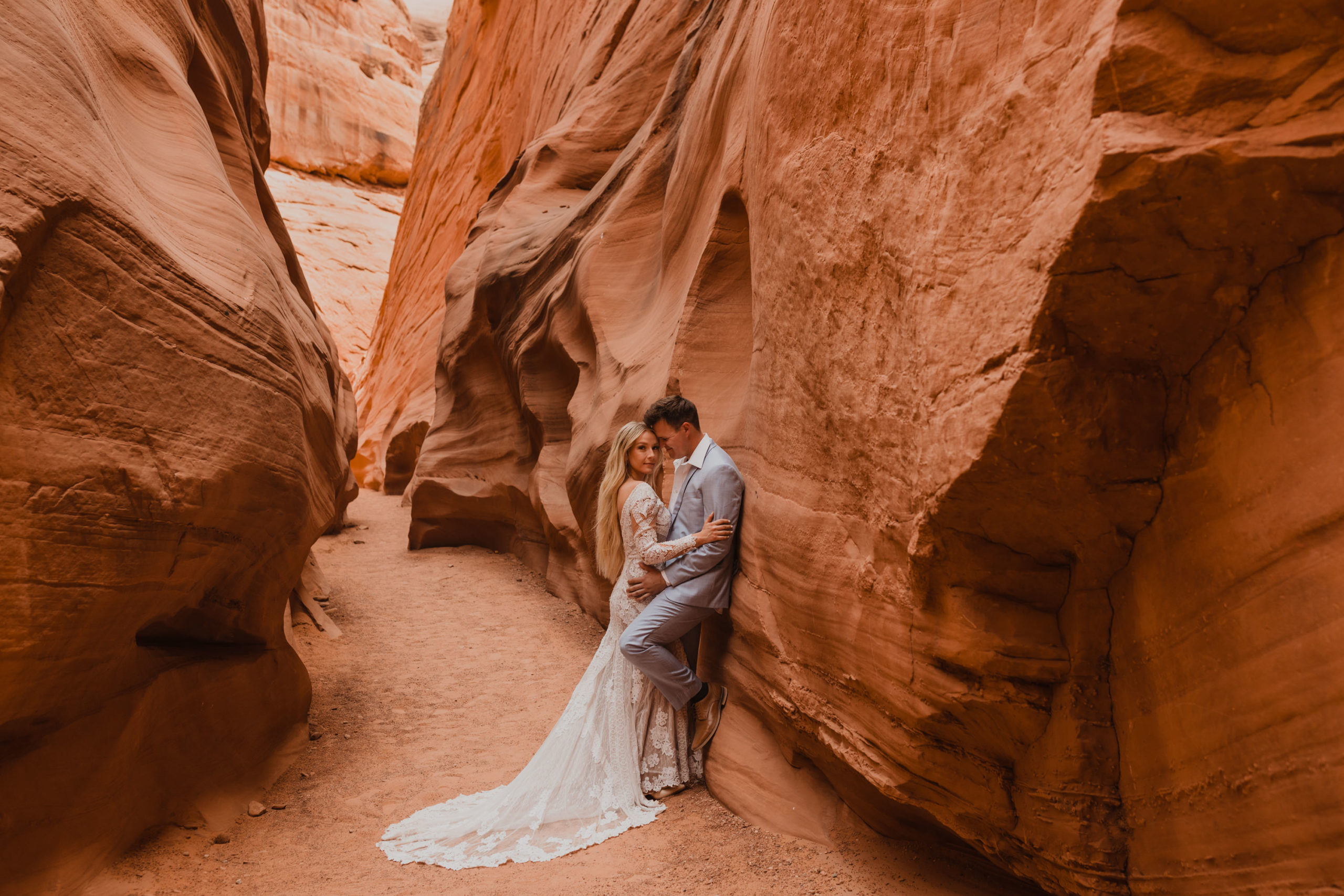 bride and groom hug in slot canyon during their adventure elopement